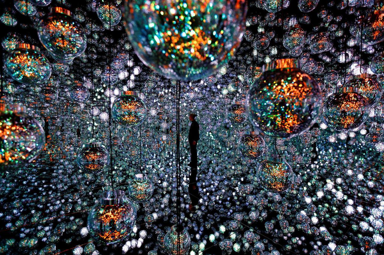 A member of the teamLab digital art group poses in an installation in preparation for the reopening of their Borderless museum in February at the Azabudai Hills complex in Tokyo