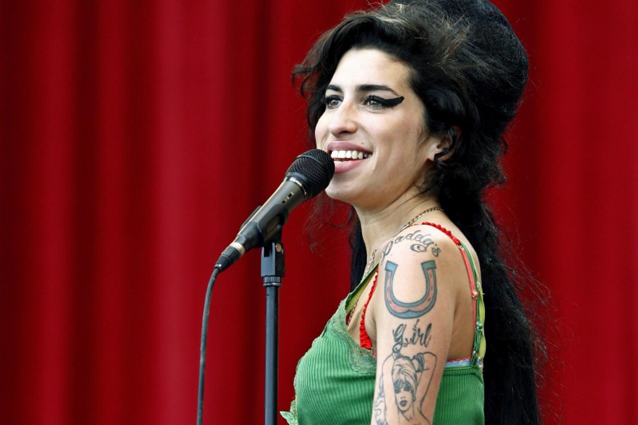 'British pop singer Amy Winehouse performs during the Glastonbury music festival in Somerset, south-west England in this June 22, 2007 file photo. Winehouse has been found dead at her home in north Lo
