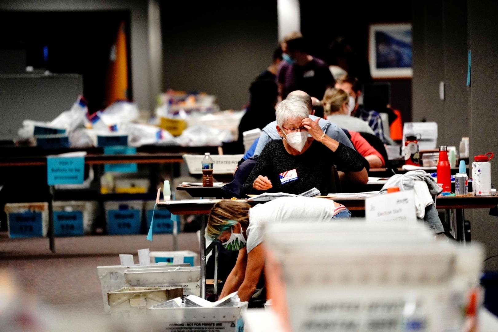 Counting absentee ballots at Milwaukee Central Count A poll worker gestures while processing absentee ballots Milwaukee Central Count the night of Election Day in Milwaukee, Wisconsin, U.S., November 3, 2020. REUTERS/Bing Guan BING GUAN