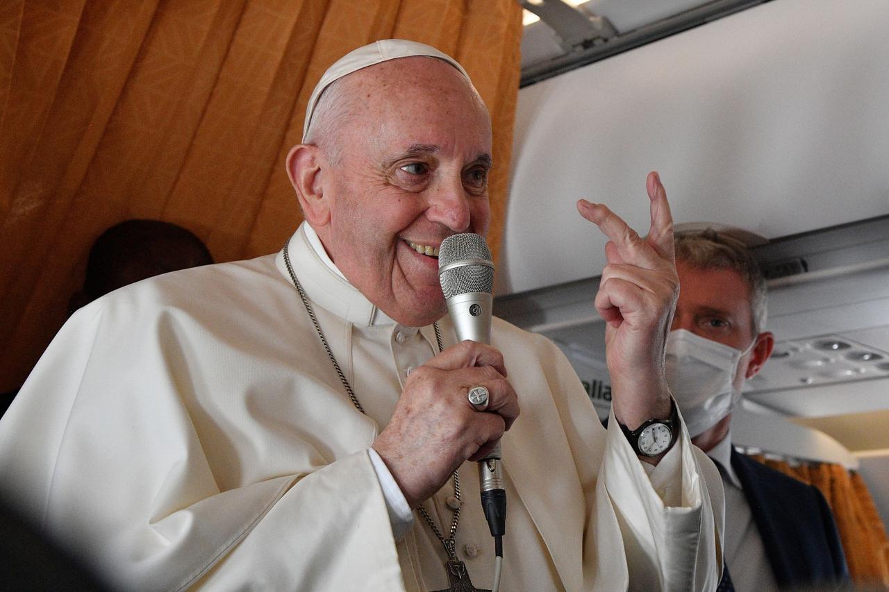 Pope Francis speaks to the media on board an Alitalia aircraft