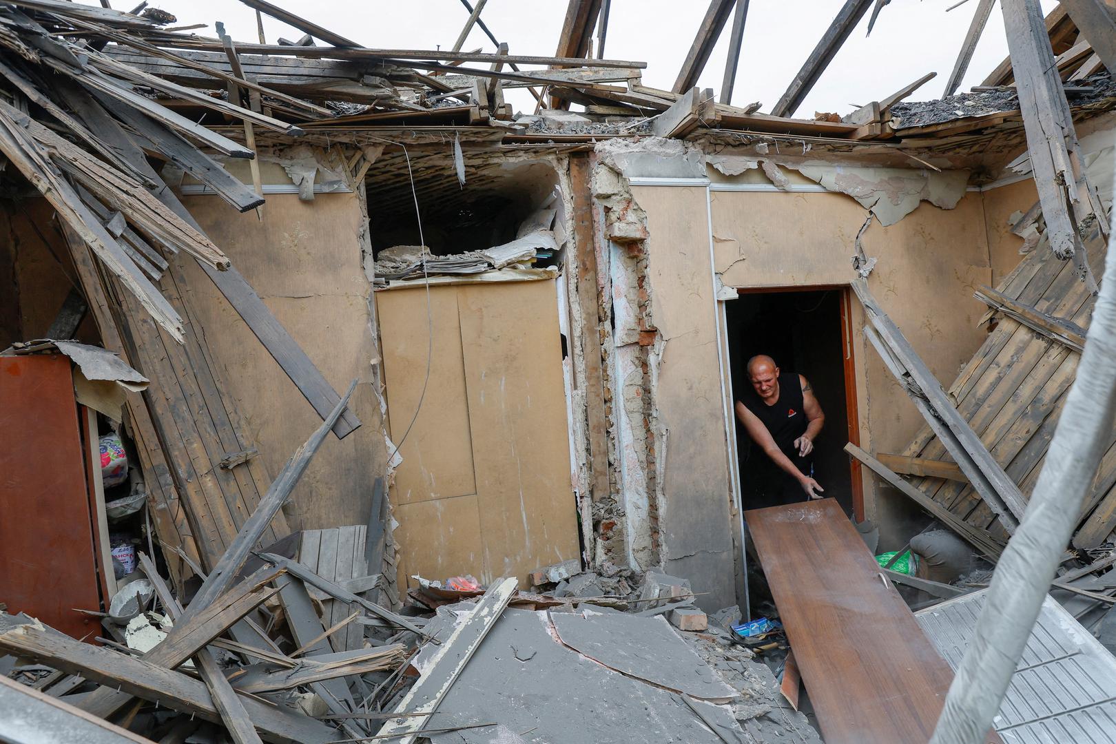 Local resident Sergei Khopta, 45, clears debris inside the destroyed house of his mother, who was taken to an intensive care unit of a hospital after she was seriously wounded by shelling, which local Russian-installed authorities called a Ukrainian military strike, in the course of Russia-Ukraine conflict in Donetsk, Russian-controlled Ukraine, April 26, 2024. REUTERS/Alexander Ermochenko     TPX IMAGES OF THE DAY Photo: Alexander Ermochenko/REUTERS