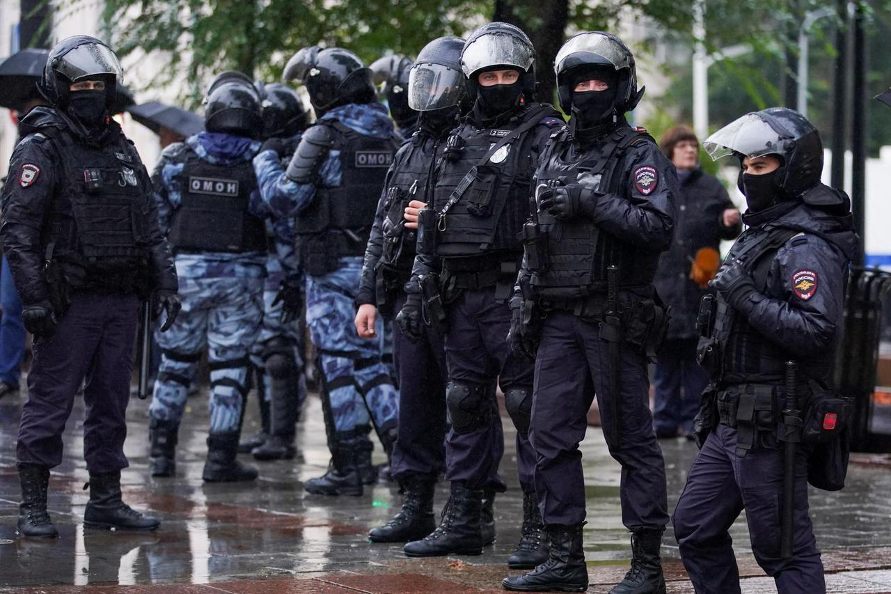 Russian police officers stand guard during a rally in Moscow