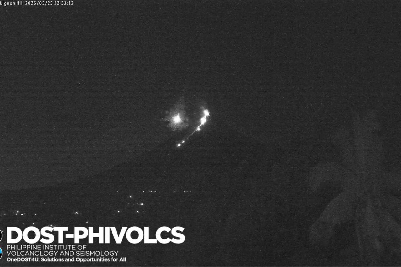 Moment meteor passes by the slopes of erupting Mayon volcano