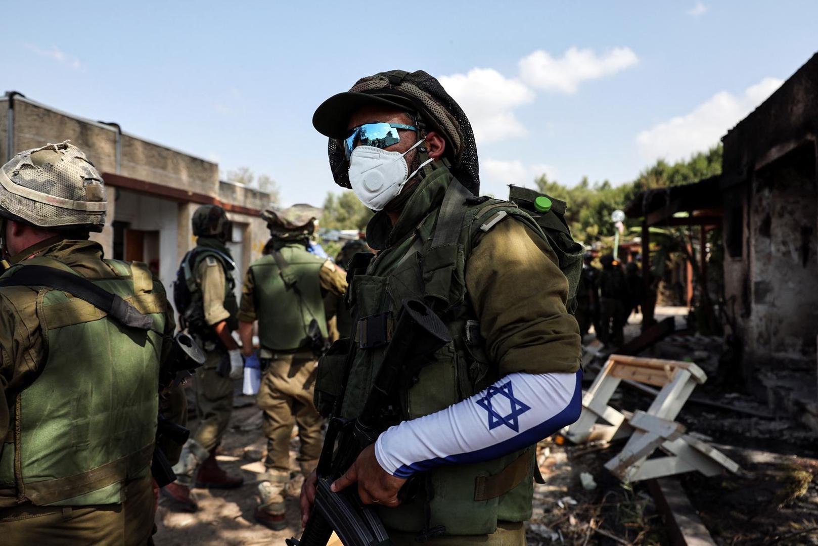 An Israeli soldier wears a mask as he looks on following an attack by Gazan militants on Kibbutz Kfar Aza, in southern Israel, October 10, 2023. REUTERS/Violeta Santos Moura Photo: VIOLETA SANTOS MOURA/REUTERS