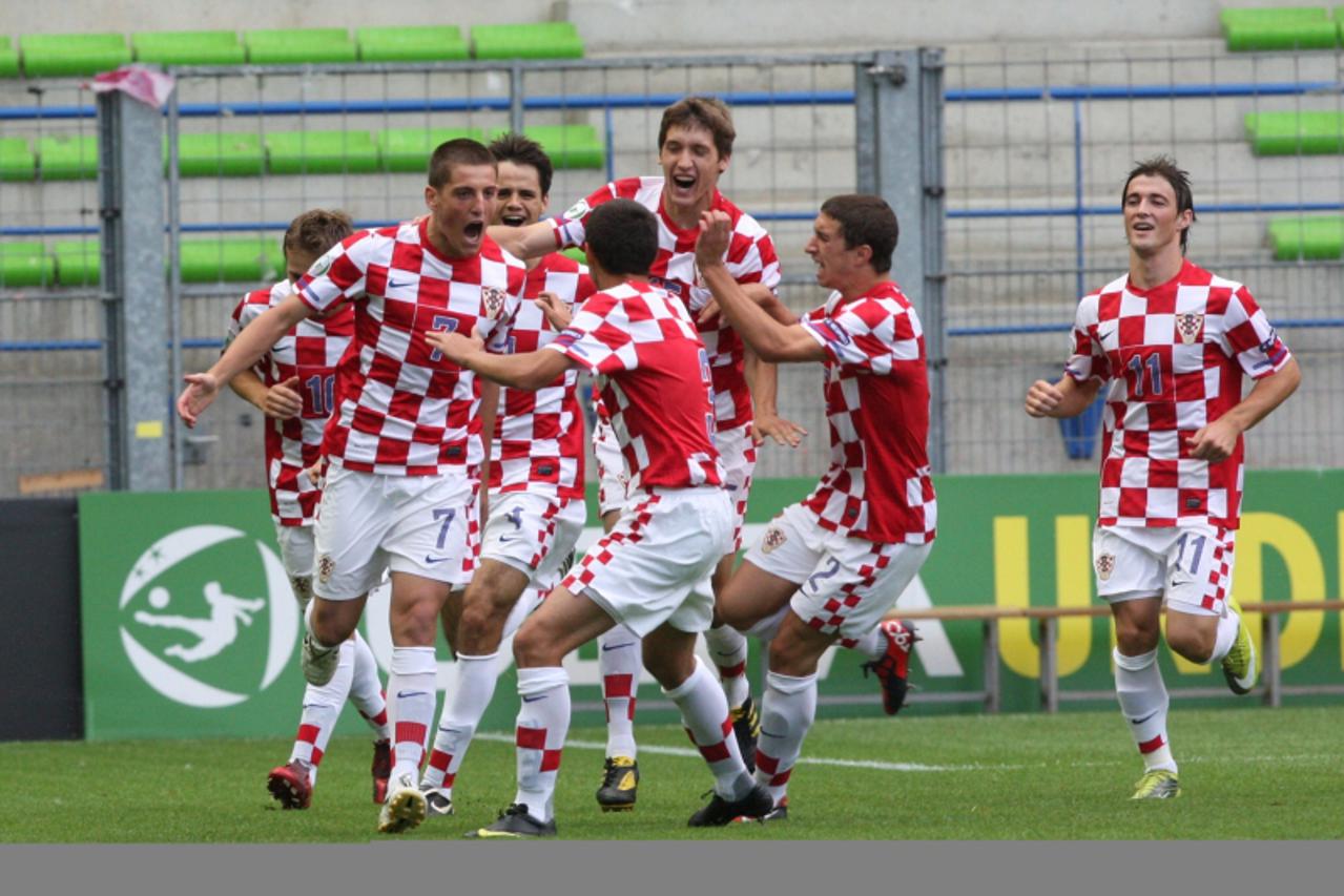 'Croatian players celebrate after scoring during the UEFA under 19 semi-final match France versus Croatia, at the d\'Ornano stadium on July 27, 2010 in Caen, northwestern France.  AFP  PHOTO KENZO TRI