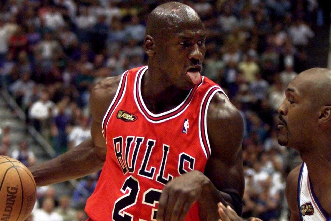 FILE PHOTO: Chicago Bulls guard Michael Jordan of the defending NBA champion Chicago Bulls drives to the hoop ag..