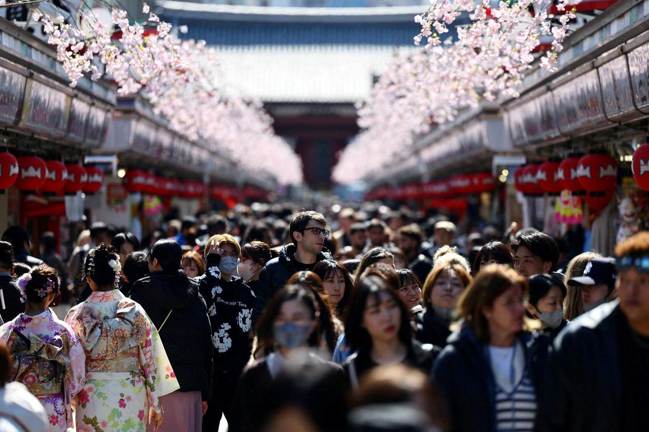 FILE PHOTO: Visitors walk along Nakamise-dori street at Asakusa district in Tokyo