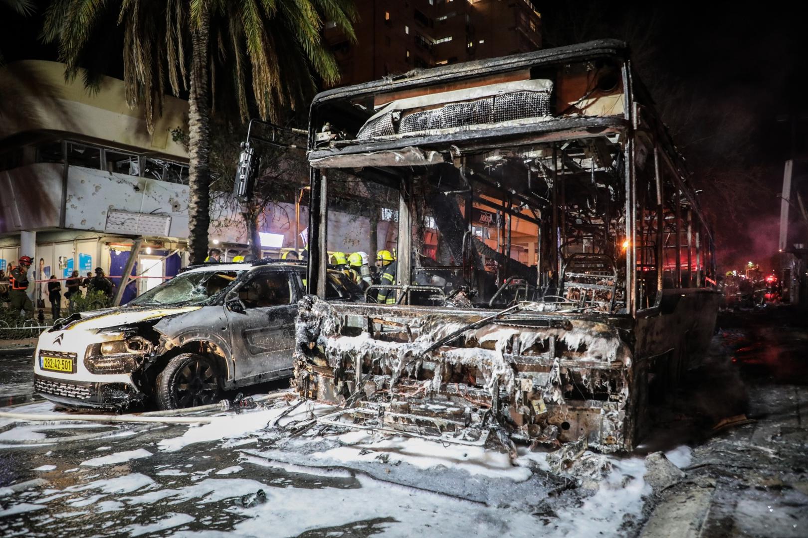 11 May 2021, Israel, Holon: Israeli firefighters work around burnt bus and car, after they were hit by a rocket fired by the Palestinian Islamist movement Hamas from Gaza towards Israel amid the escalating flare-up of Israeli-Palestinian violence. Photo: Oren Ziv/dpa /DPA/PIXSELL