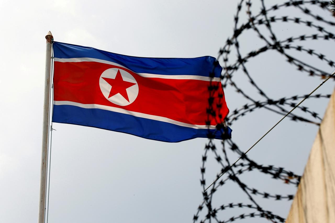FILE PHOTO: A North Korea flag flutters next to concertina wire at the North Korean embassy in Kuala Lumpur