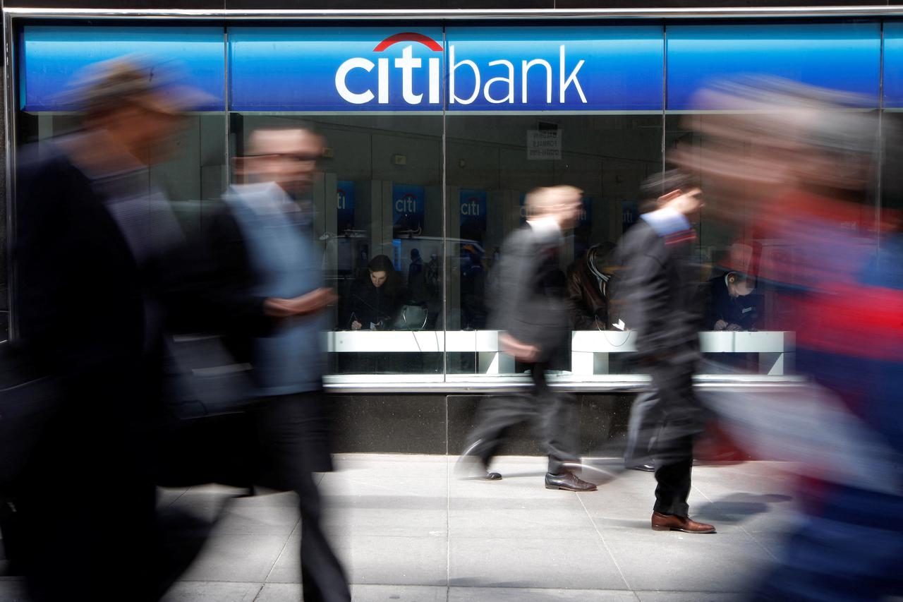 FILE PHOTO: People walk past a CitiBank branch on Avenue of the Americas, in New York