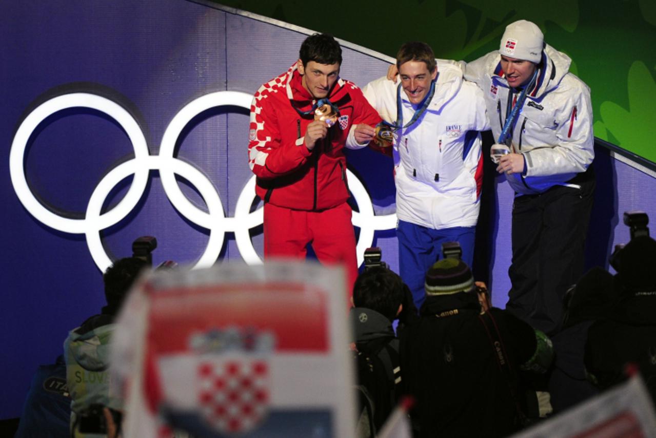 'French gold medallist Vincent (C), Norwegian silver medallist Emil Hegle Svendsen (R) and Croatian bronze medallist Jakov Fak Jay pose for photographers during the medal ceremony for the Men\'s Biath