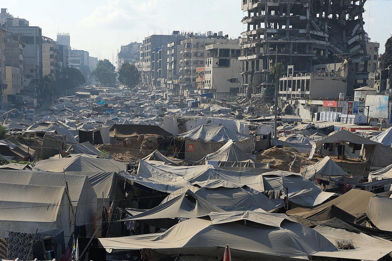 Palestinians displaced by the Israeli military offensive take shelter in a tent camp in Gaza City