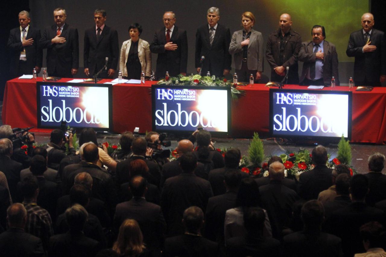 \'Members of the leadership of Croatian National Parliament stand as the national anthem is being played before a meeting in Mostar April 19, 2011. Bosnian Croat major political parties meet in the et