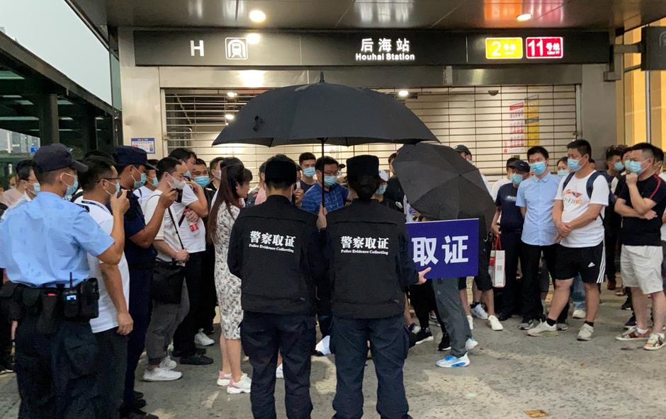 People protest to demand repayment of loans and financial products at the Evergrande's headquarters, in Shenzhen