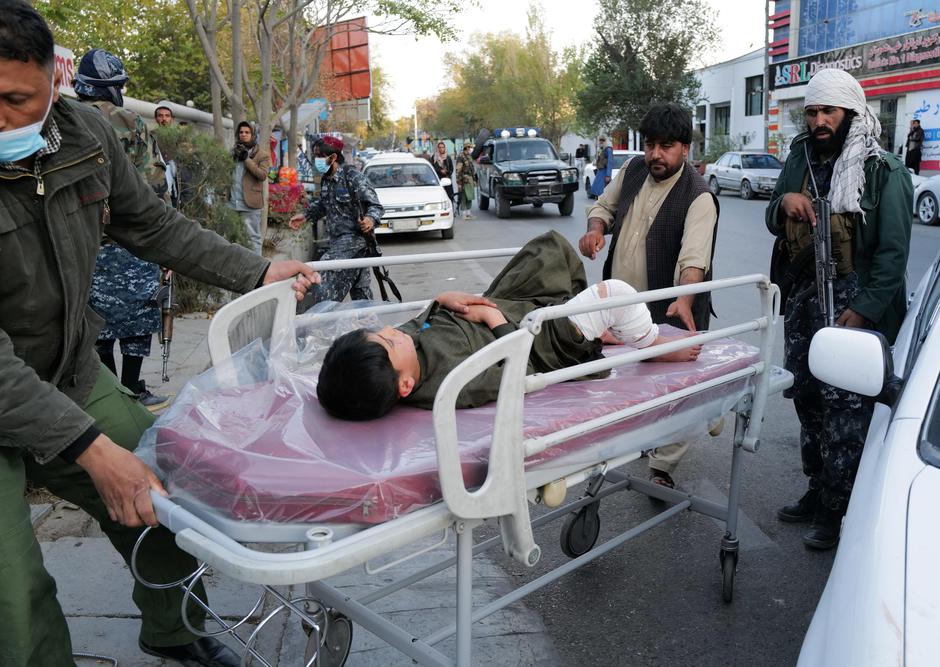 Boy, injured during a blast, lies on stretcher at the entrance of a hospital in Kabul