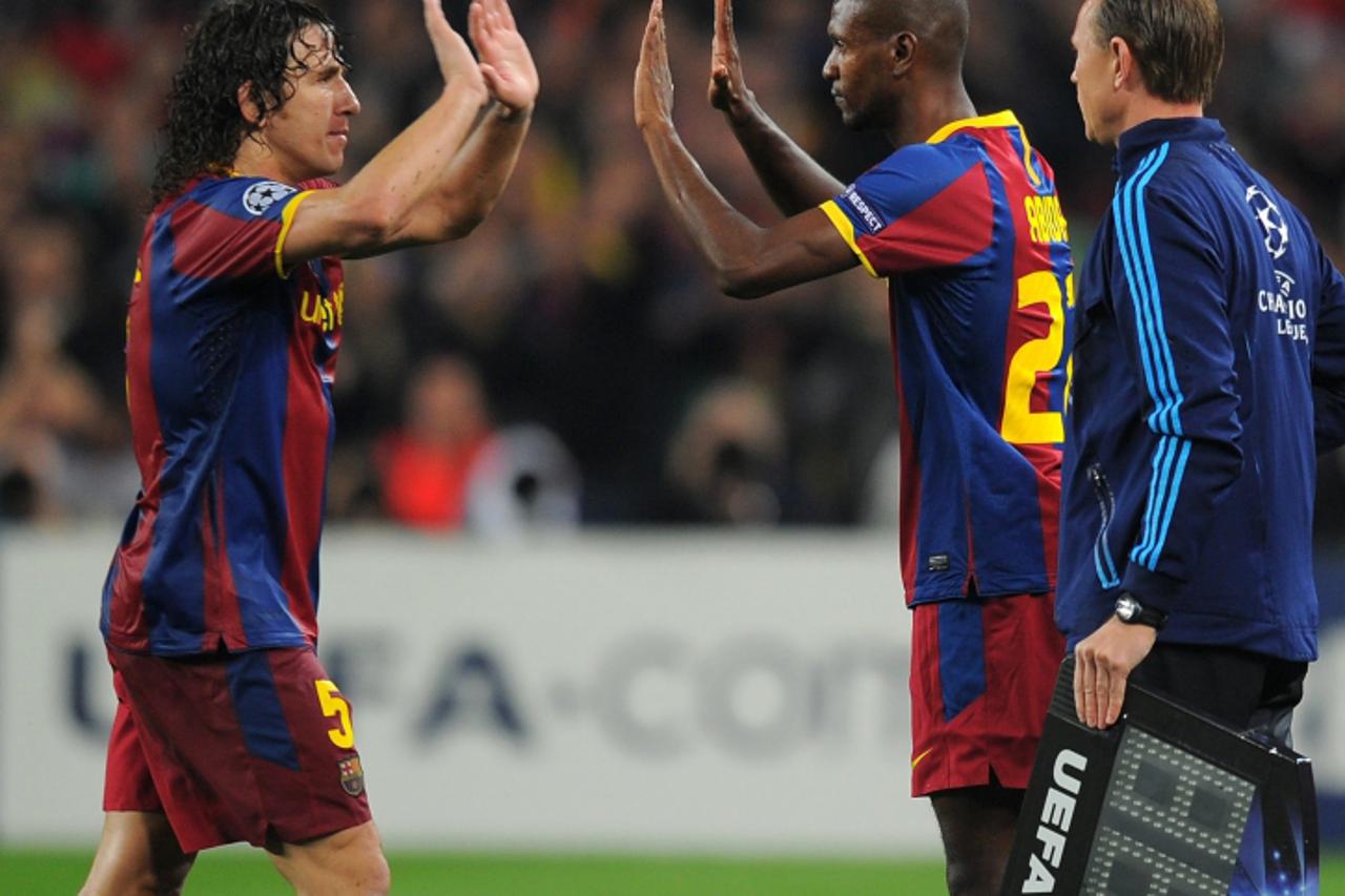 'Barcelona\'s French defender Eric Abidal (C) enters the field to replace Barcelona\'s captain Carles Puyol (L) during the Champions League semi-final second leg football match between Barcelona and R