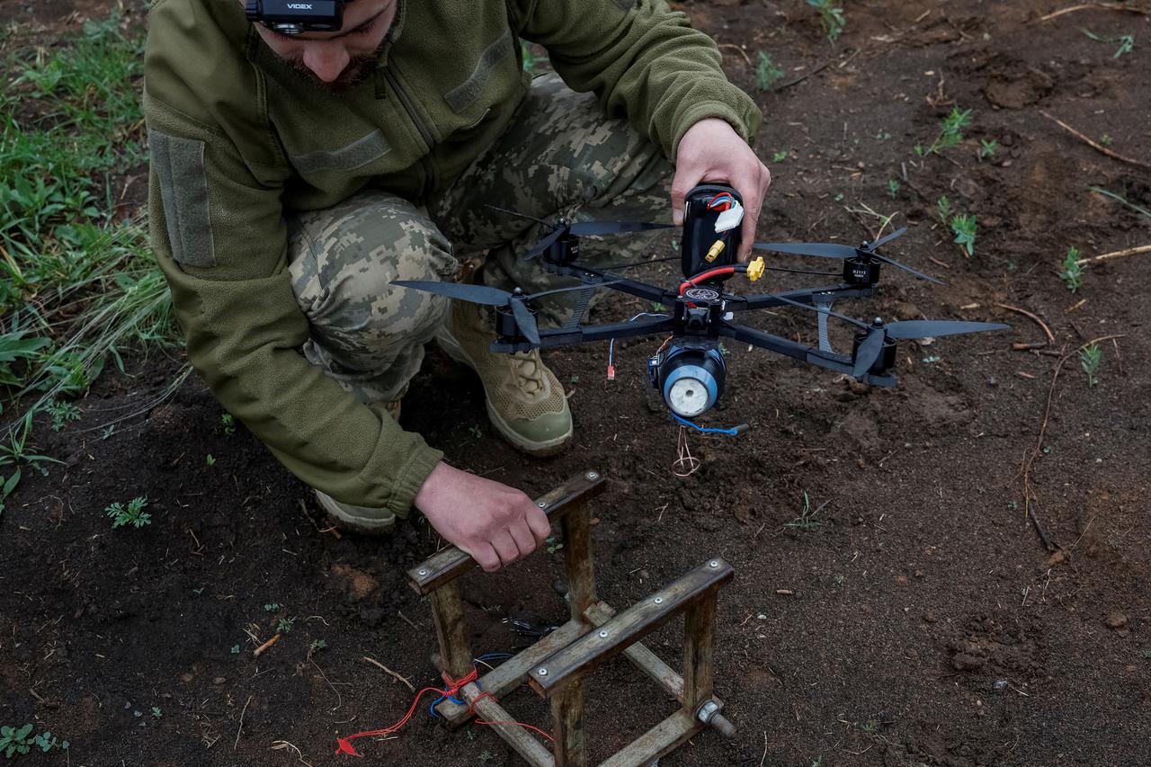FILE PHOTO: Ukrainian service members prepare FPV drones during the unilaterally proposed three-day ceasefire declared by Russia, near a frontline in Dnipropetrovsk region