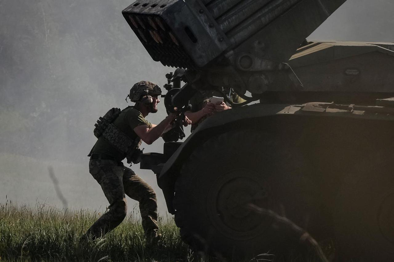 Ukrainian servicemen fire a Grad MLRS towards Russian troops in Donetsk region