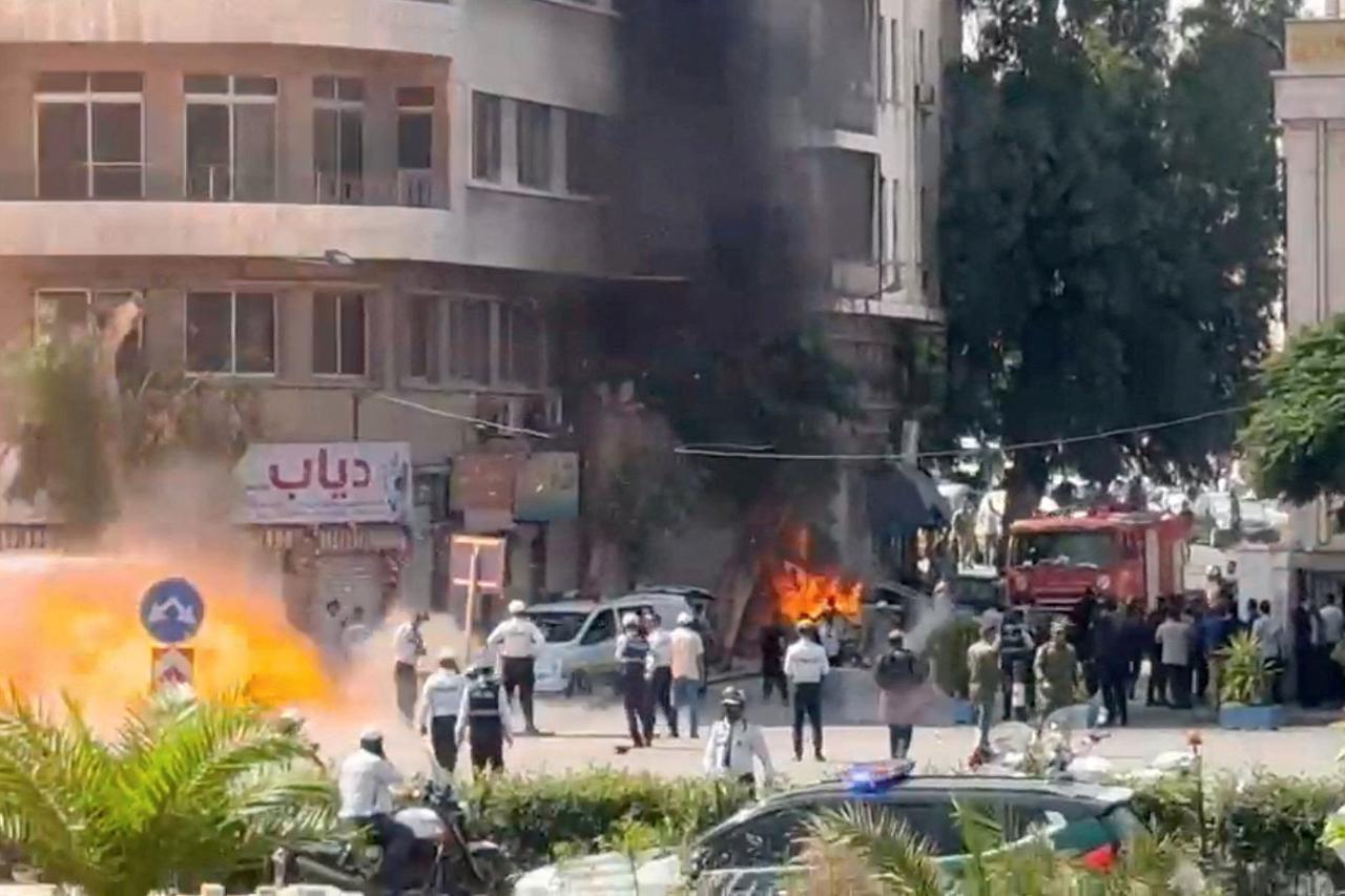 Explosive devices blow up near a hotel where French President Emmanuel Macron was meant to be staying, in Damascus