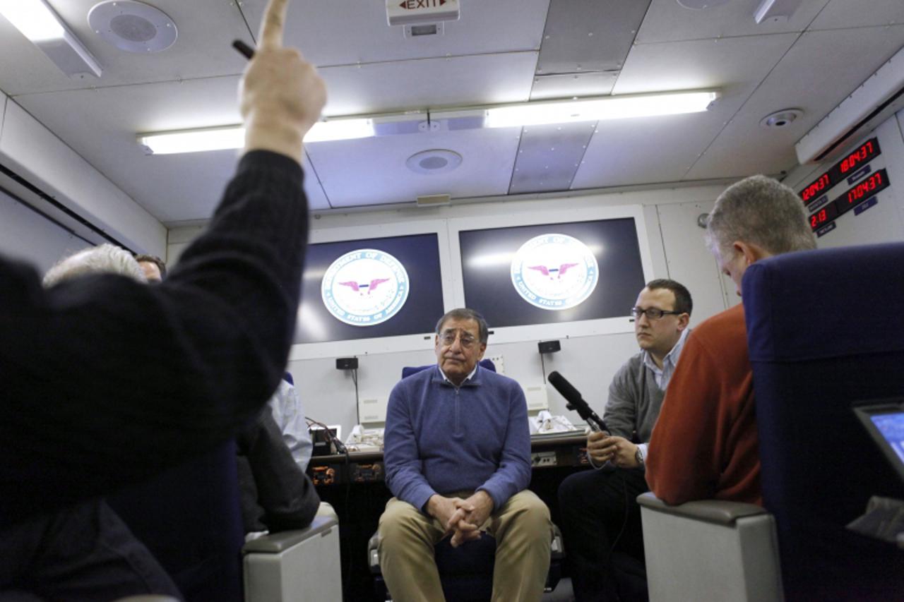 'US Defense Secretary Leon Panetta(C), answers questions from the media on board the E-4B plane en route to a NATO conference in Brussels, Belgium  on  February 1, 2012. AFP PHOTO/POOL/Jacquelyn Marti