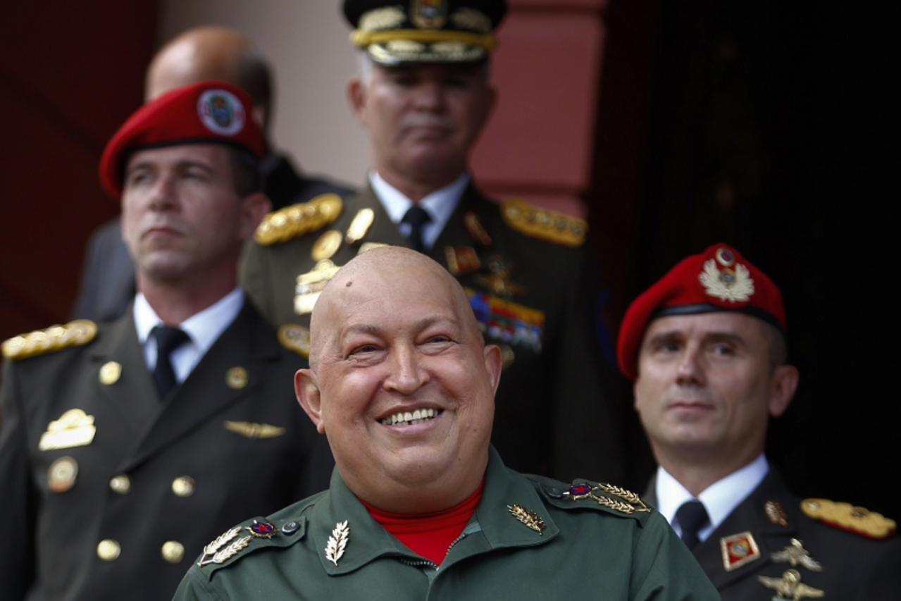 'Venezuela\'s President Hugo Chavez smiles after a meeting with Belarus\' government representative Viktor Sheiman at the Miraflores Palace in Caracas October 3, 2011. REUTERS/Carlos Garcia Rawlins(VE