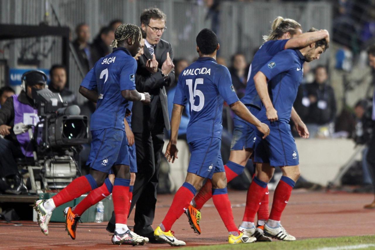 'France\'s coach Laurent Blanc (C rear) reacts after Yoann Gourcuff (R) scored the second goal for his team against Luxembourg in their Euro 2012 qualifying soccer match at the Josy Barthel stadium in