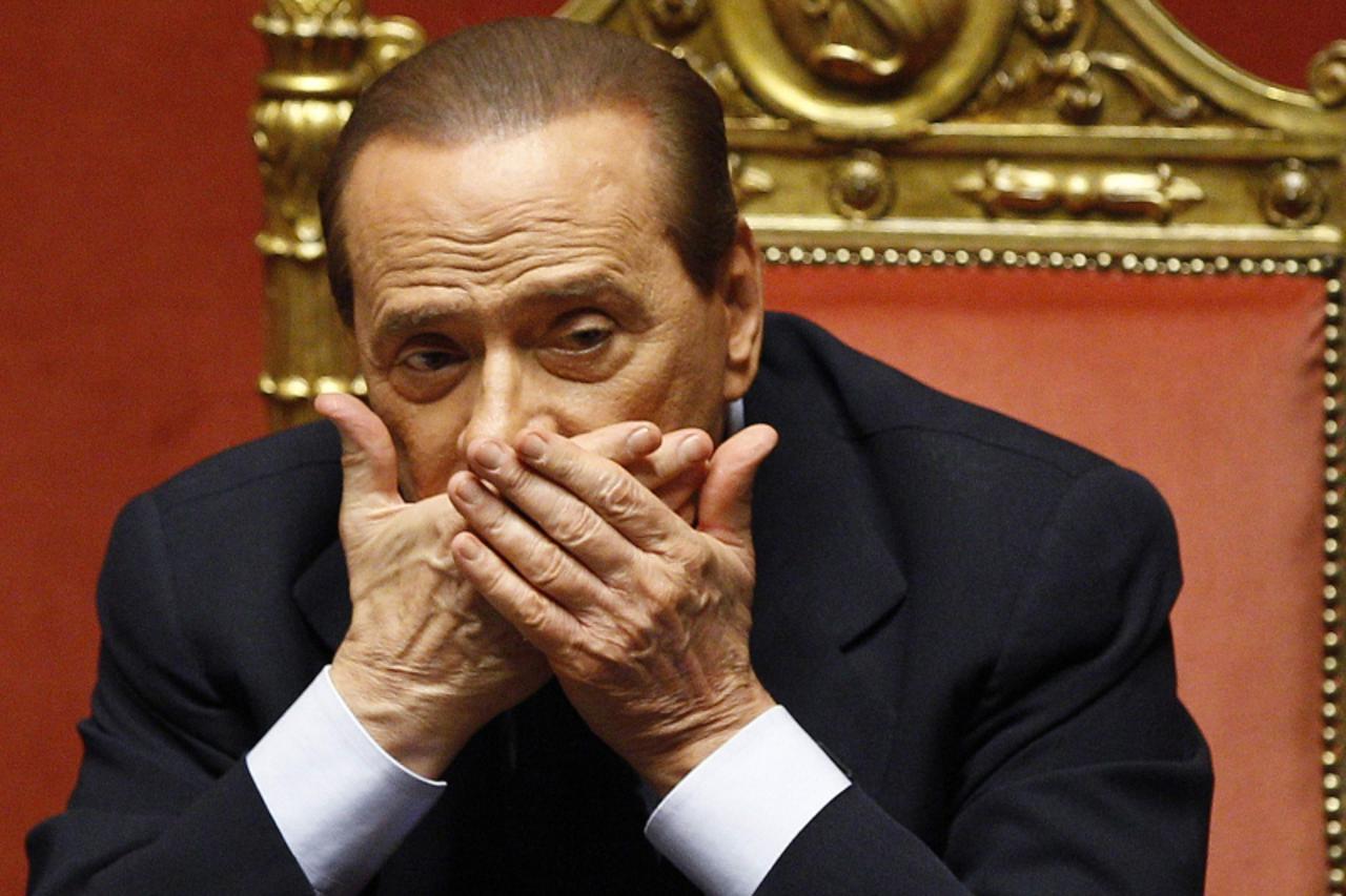 'Italian Prime Minister Silvio Berlusconi reacts during a debate at the Senate in Rome in this June 21, 2011 file photo. Berlusconi on November 7, 2011 denied reports he was about to resign.   REUTERS