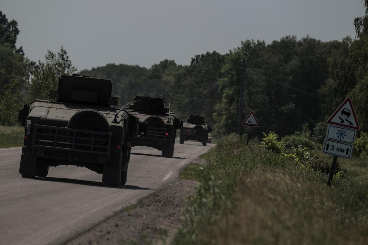 HMMWV (Humvee) vehicles move along a road near the Ukraine-Russia border in Kharkiv region