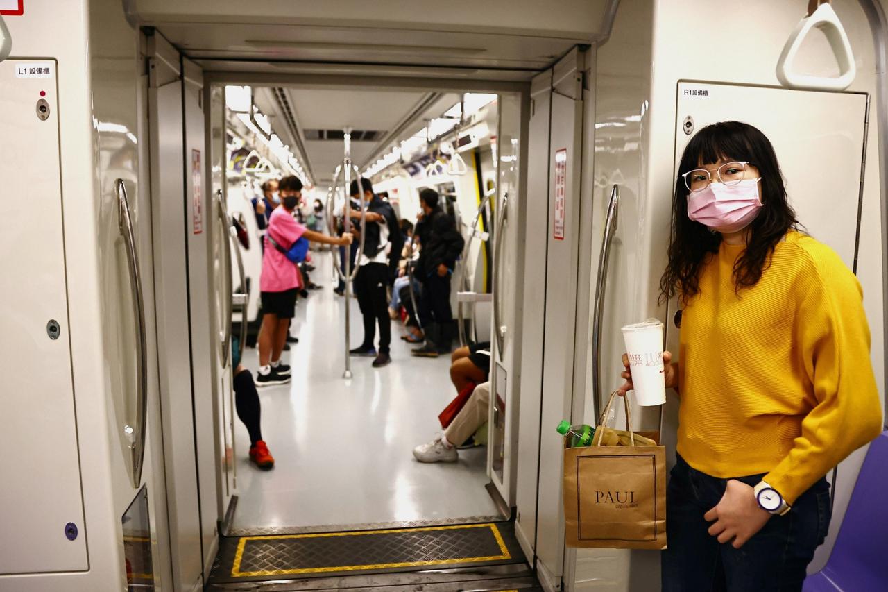 A woman wears a protective mask to prevent the spread of the coronavirus disease (COVID-19) while riding the metro in Taipei