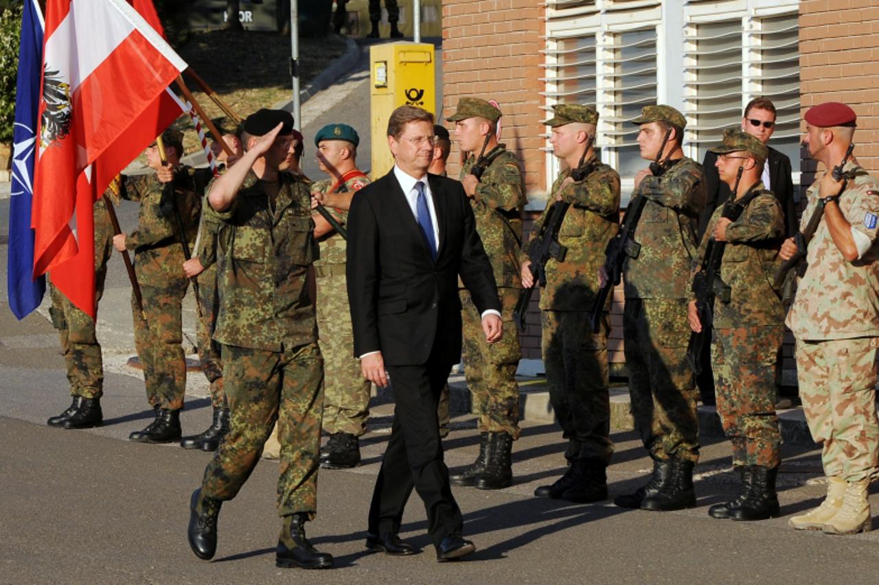 'German Foreign Minister Guido Westerwelle reviews German KFOR soldiers serving in Kosovo during his visit at the German KFOR Camp near the town of Prizren on August 27, 2010. After talks with politic