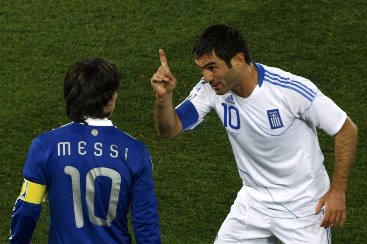 'Greece\'s Giorgos Karagounis (R) gestures to Argentina\'s Lionel Messi during a 2010 World Cup Group B soccer match at Peter Mokaba stadium in Polokwane June 22, 2010.    REUTERS/David Gray (SOUTH AF