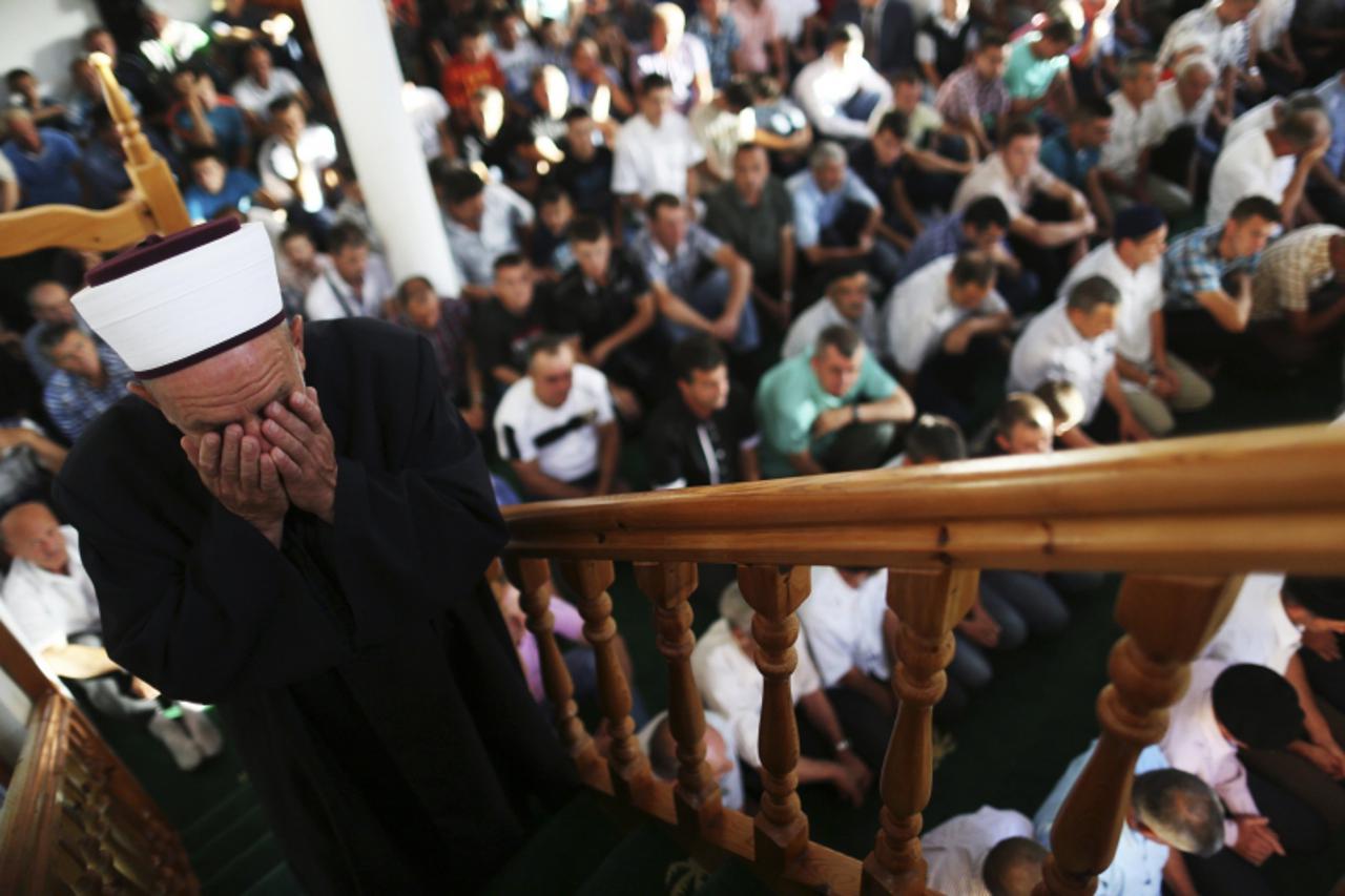 'A Bosnian Muslim priest leads early morning prayers on the first day of Eid al-Fitr in the village of Mjestova Ravna, 90 km (56 miles) from the capital Sarajevo, August 8, 2013. Eid al-fitr marks the