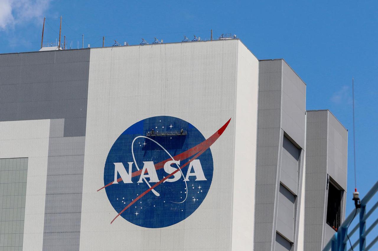 FILE PHOTO: Workers pressure wash the logo of NASA on the Vehicle Assembly Building, in Cape Canaveral