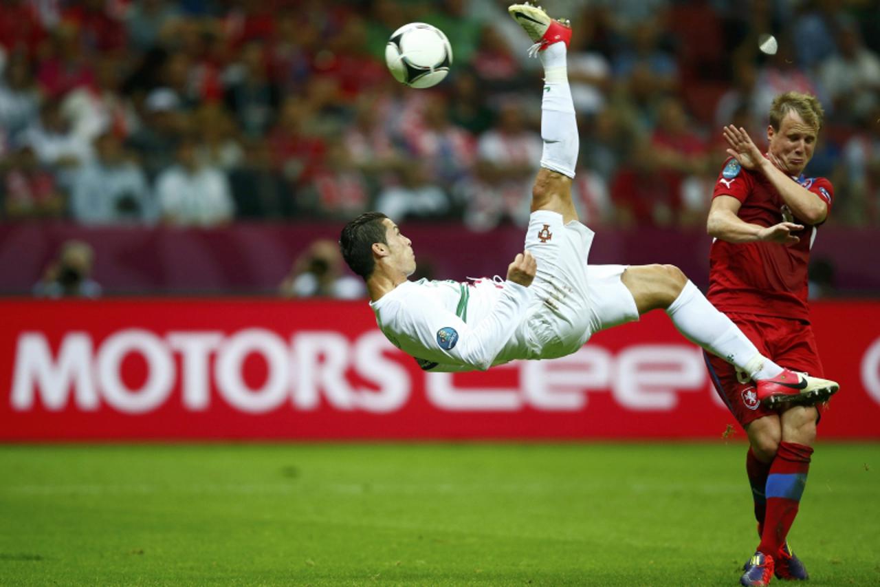 'Portugal\'s Cristiano Ronaldo kicks the ball in front of Czech Republic\'s Michal Kadlec (R) during their Euro 2012 quarter-final soccer match at the National stadium in Warsaw, June 21, 2012.       
