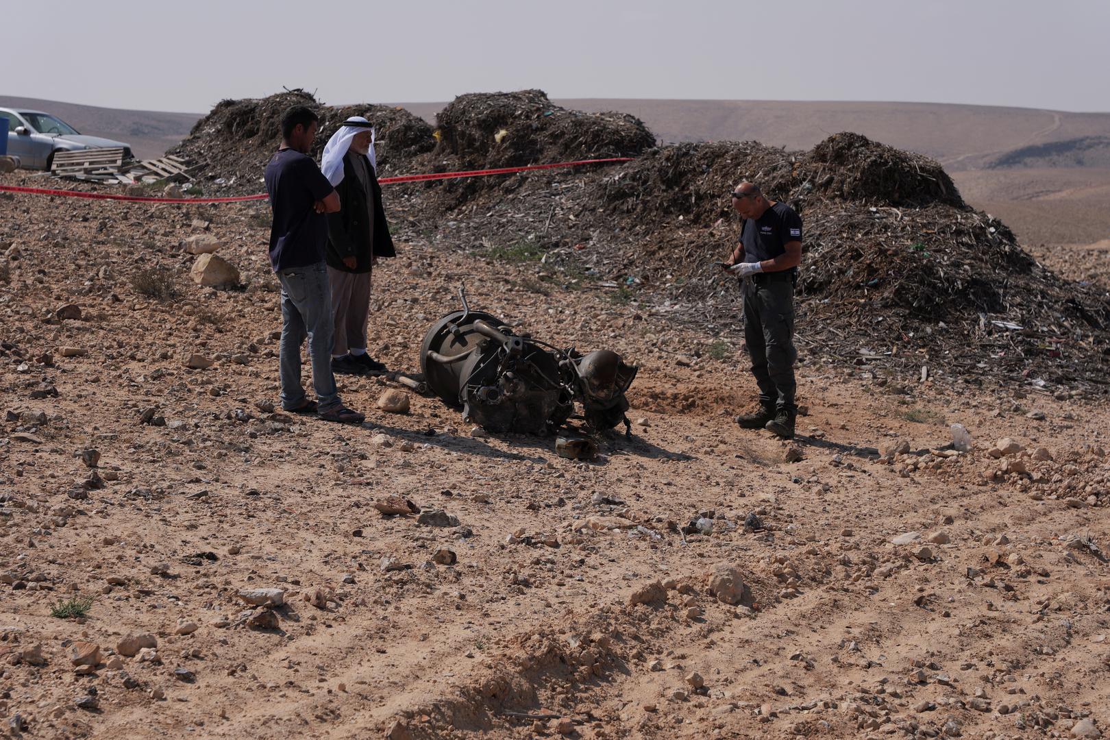 A police officer and residents inspect the remains of a rocket booster that, according to Israeli authorities critically injured a 7-year-old girl, after Iran launched drones and missiles towards Israel, near Arad, Israel, April 14, 2024. REUTERS/Christophe van der Perre Photo: CHRISTOPHE VAN DER PERRE/REUTERS