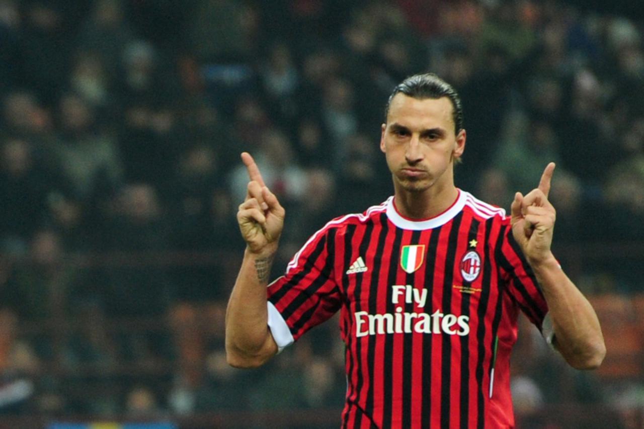 'AC Milan\'s Swedish forward Zlatan Ibrahimovic celebrates after scoring a penalty during the Italian Serie A football match between AC  Milan and Chievo on November 27, 2011 at San Siro Stadium in Mi