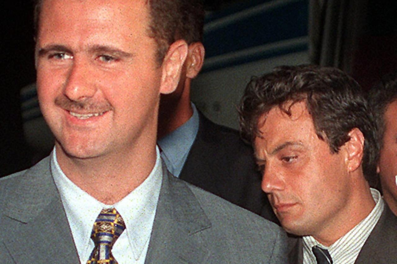 '(FILES) A picture taken on August 22, 1999 shows then Colonel Bashar al-Assad (L), who is the current Syrian President, arriving with Manaf Tlass, son of then Syrian Defence Minister Mustafa Tlass in