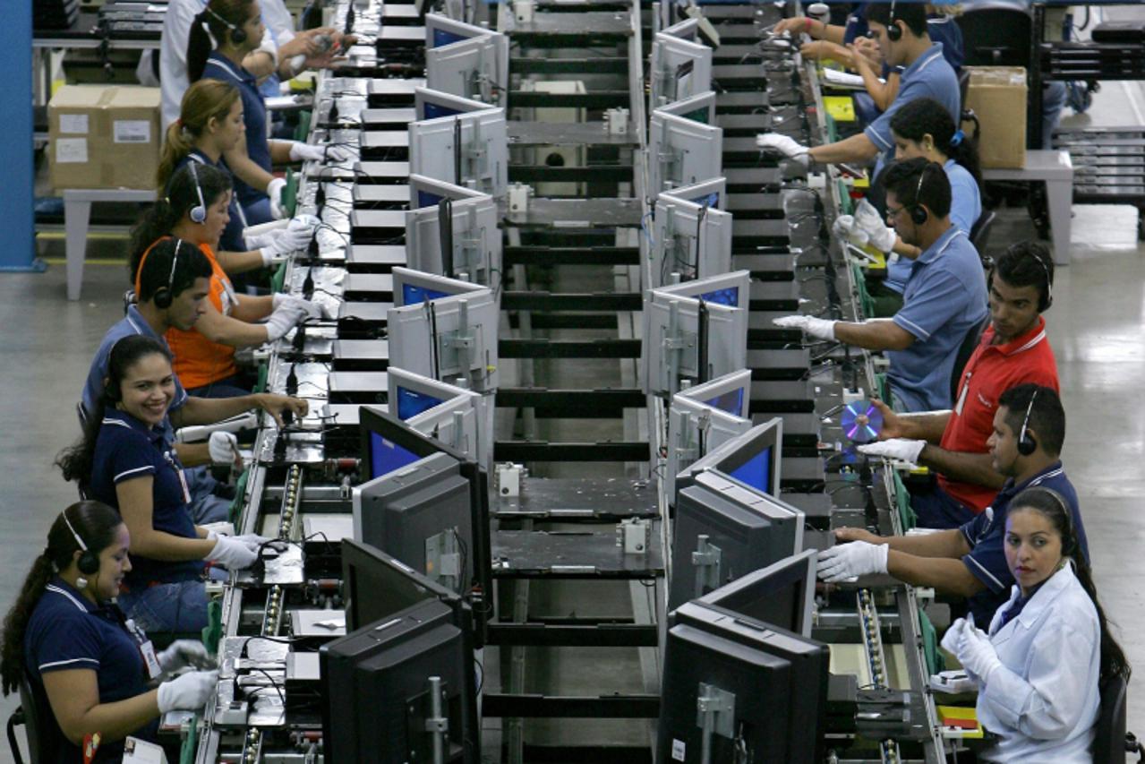'Workers check new DVD players at the assembly line of Dutch electronics company Philips at the industrial pole in Manaus, northern Brazil, on September 12, 2008. Overpassing analysts\' estimation, th