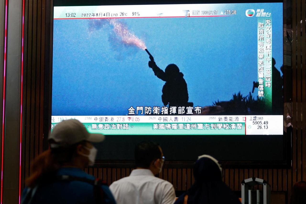 A TV screen shows that China's People's Liberation Army has begun military exercises including live firing on the waters and in the airspace surrounding the island of Taiwan, in Hong Kong
