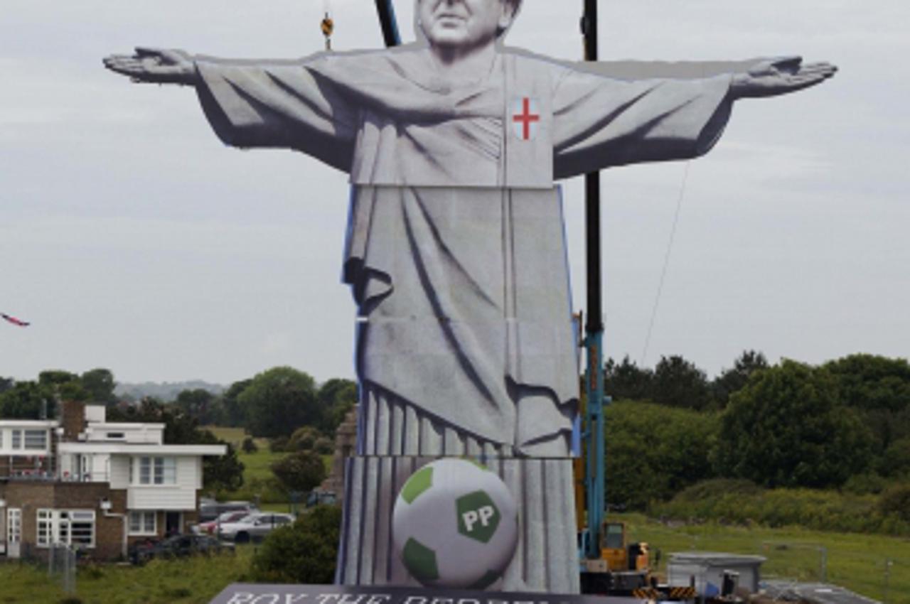 'England\'s national football team manager Roy Hodgson appears in a 108 foot tall (33 metre) reproduction of Rio de Janeiro\'s iconic Christ the Redeemer statue above the White Cliffs of Dover June 7,