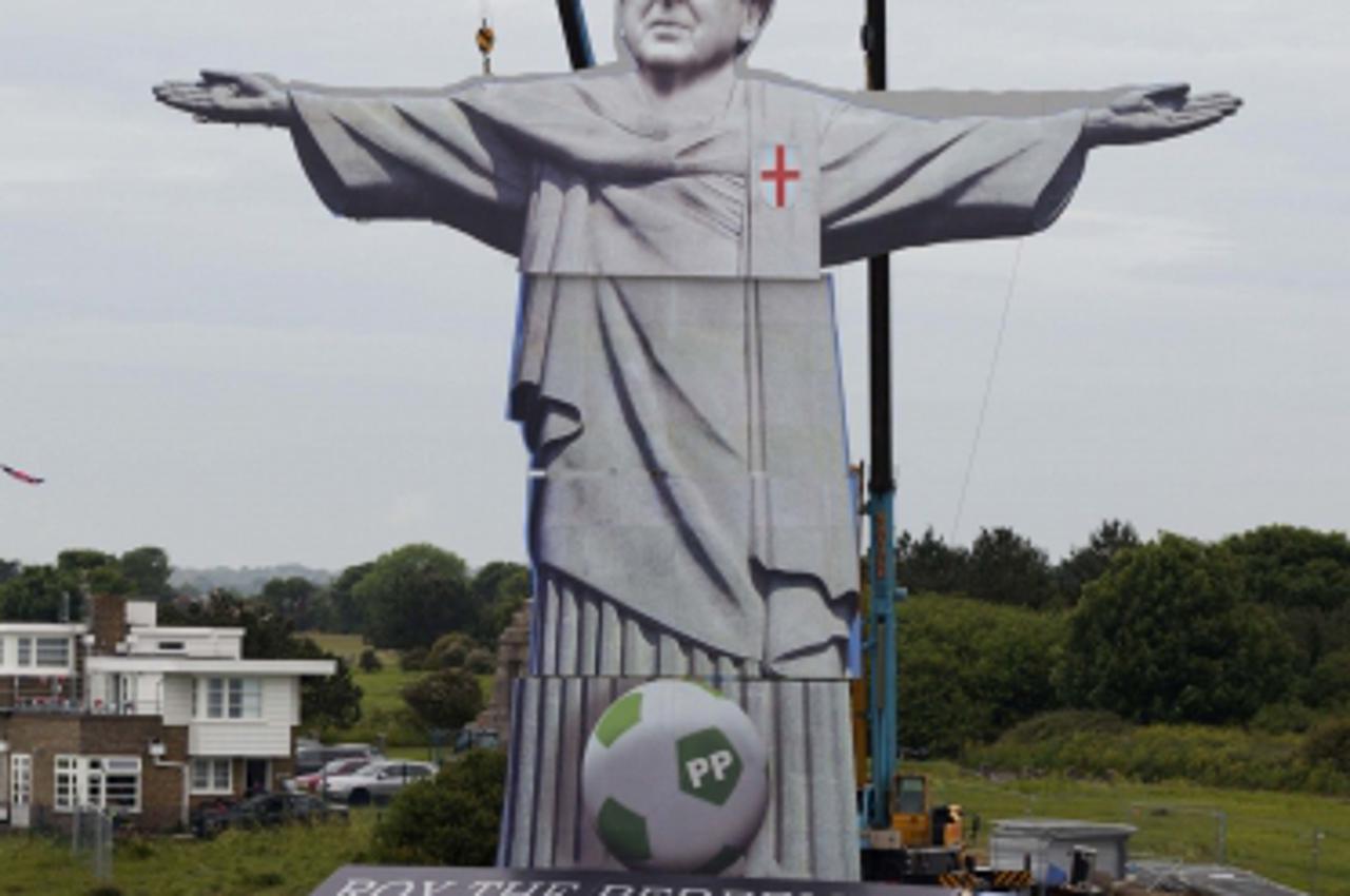 'England\'s national football team manager Roy Hodgson appears in a 108 foot tall (33 metre) reproduction of Rio de Janeiro\'s iconic Christ the Redeemer statue above the White Cliffs of Dover June 7,