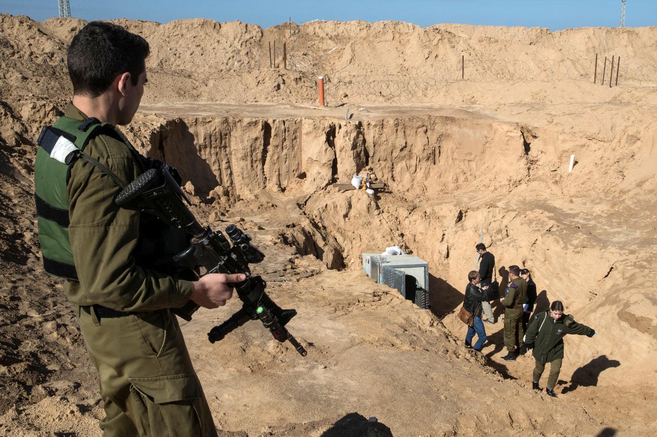 FILE PHOTO: An Israeli soldier keeps guard next to an entrance to what the Israeli military say is a cross-border attack tunnel dug from Gaza to Israel, on the Israeli side of the Gaza Strip border near Kissufim