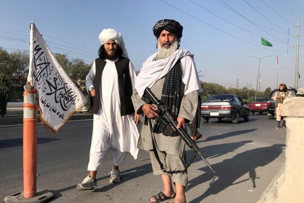 FILE PHOTO: Taliban fighter stand outside the Interior Ministry in Kabul