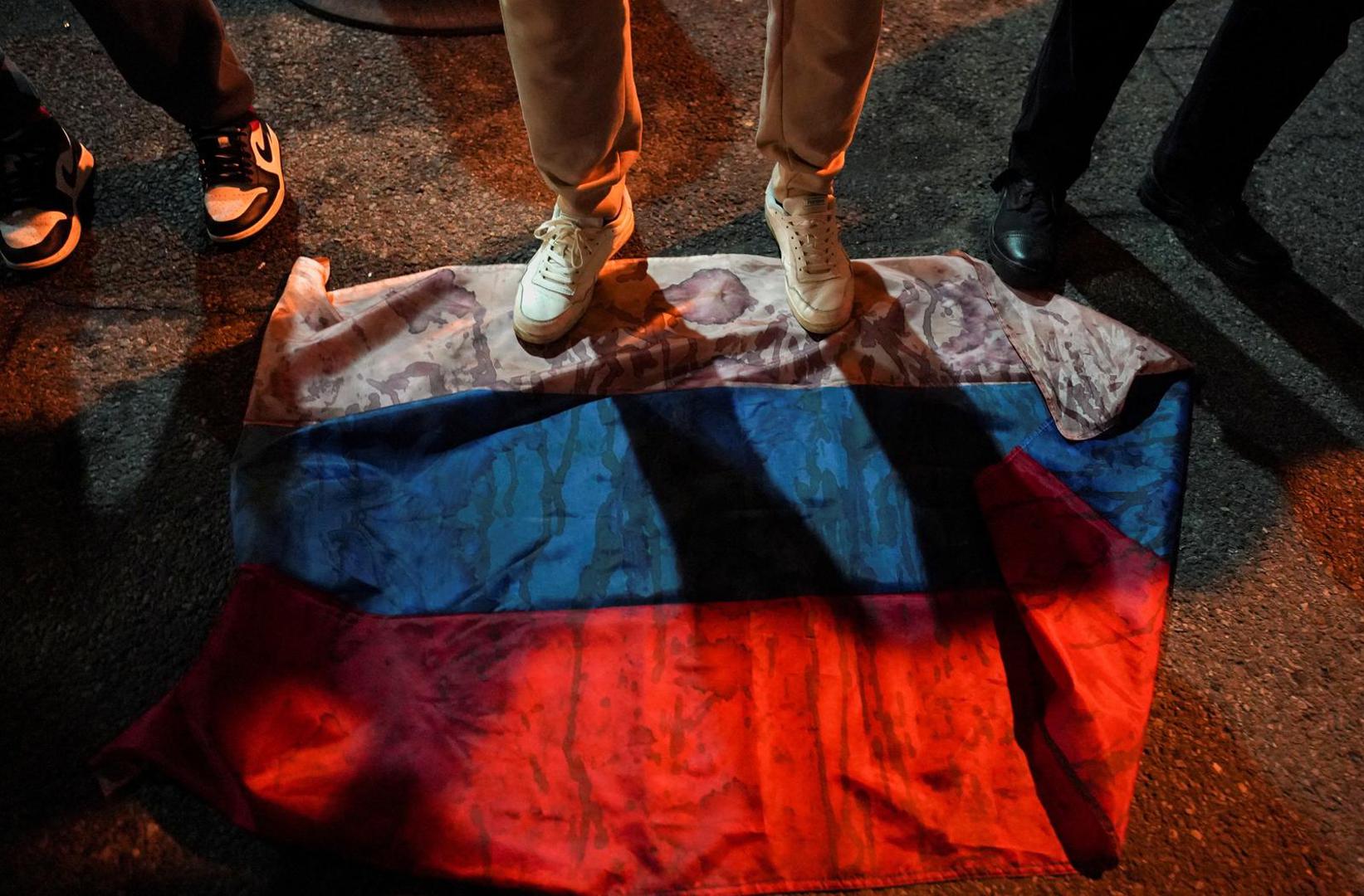 Demonstrators step on a Russian flag during "The Year of Terror: Russians Against the War" rally to show their support for Ukraine on the eve of the war's anniversary, outside the Russian Consulate in New York City, New York, U.S., February 23, 2023.  REUTERS/David 'Dee' Delgado Photo: David Dee Delgado/REUTERS