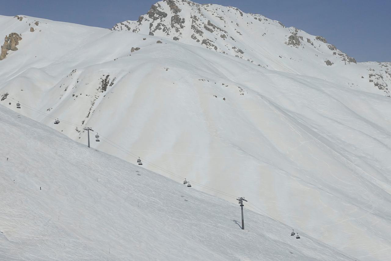 Sahara dust is seen on the snow behind a chairlift in St. Moritz