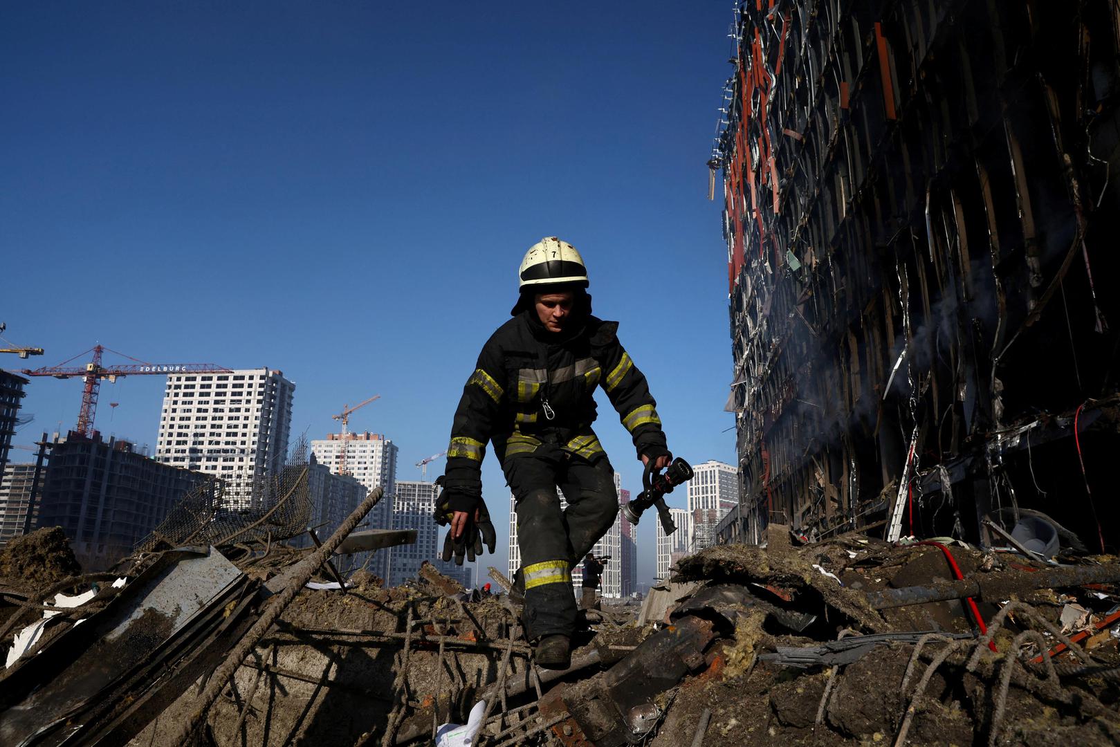 A rescuer walks through debris at the site of a bombing at a shopping center as Russia's invasion of Ukraine continues, in Kyiv, Ukraine March 21, 2022. REUTERS/Marko Djurica Photo: MARKO DJURICA/REUTERS