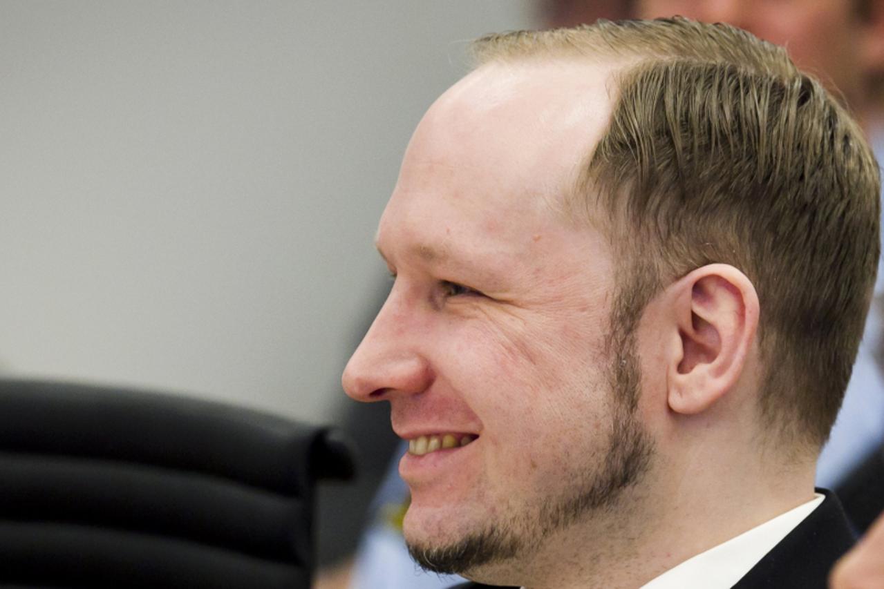 'Norwegian mass killer Anders Behring Breivik smiles during the second day of his terrorism and murder trial in Oslo April 17, 2012. Breivik, who massacred 77 people last summer, took to the stand for