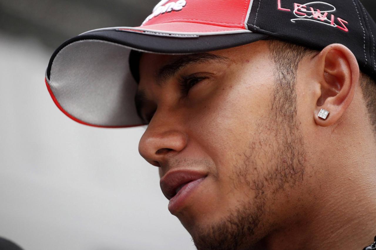 'McLaren Formula One driver Lewis Hamilton of Britain talks to the media at the paddock during a news conference in Sao Paulo  November 24, 2011. The Brazilian GP, the final race of the year, will be 