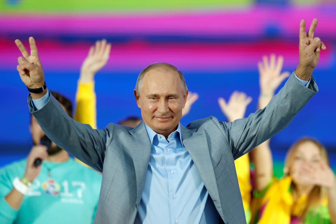 FILE PHOTO: Russian President Vladimir Putin waves to participants of the 19th World Festival of Youth and Students during the closing ceremony at the Olympic Park in Sochi