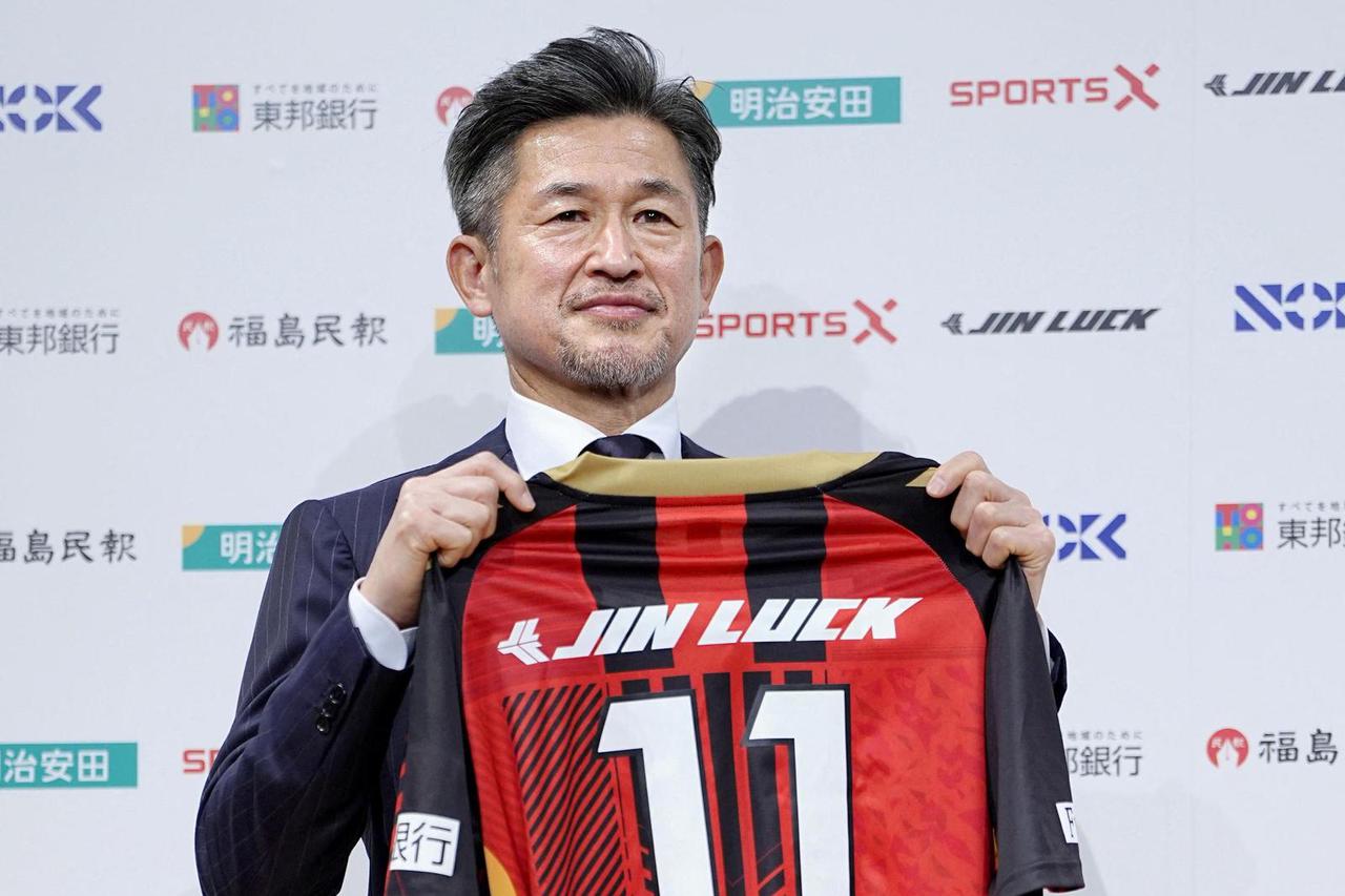 Japan's soccer player Kazuyoshi Miura poses for a photograph during his first news conference after joining Fukushima United in the J-League third division in Tokyo